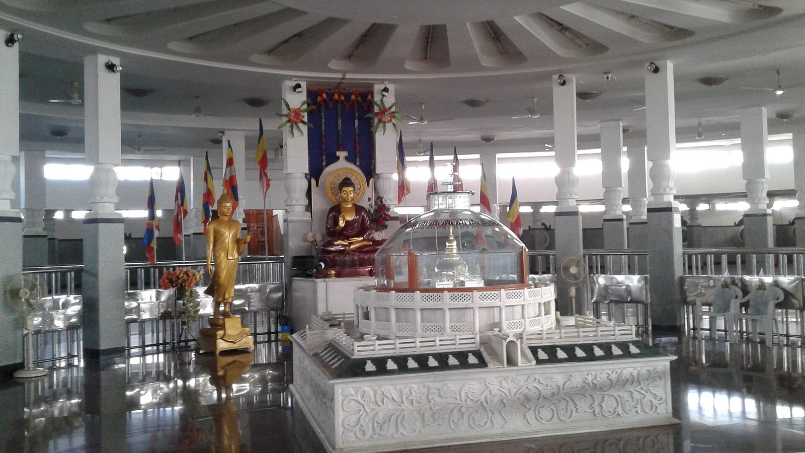 Inside Deekshabhoomi, Nagpur: an urn holding Ambedkar's ashes kept in a glass case before Buddha statues. Photographed in 2017.