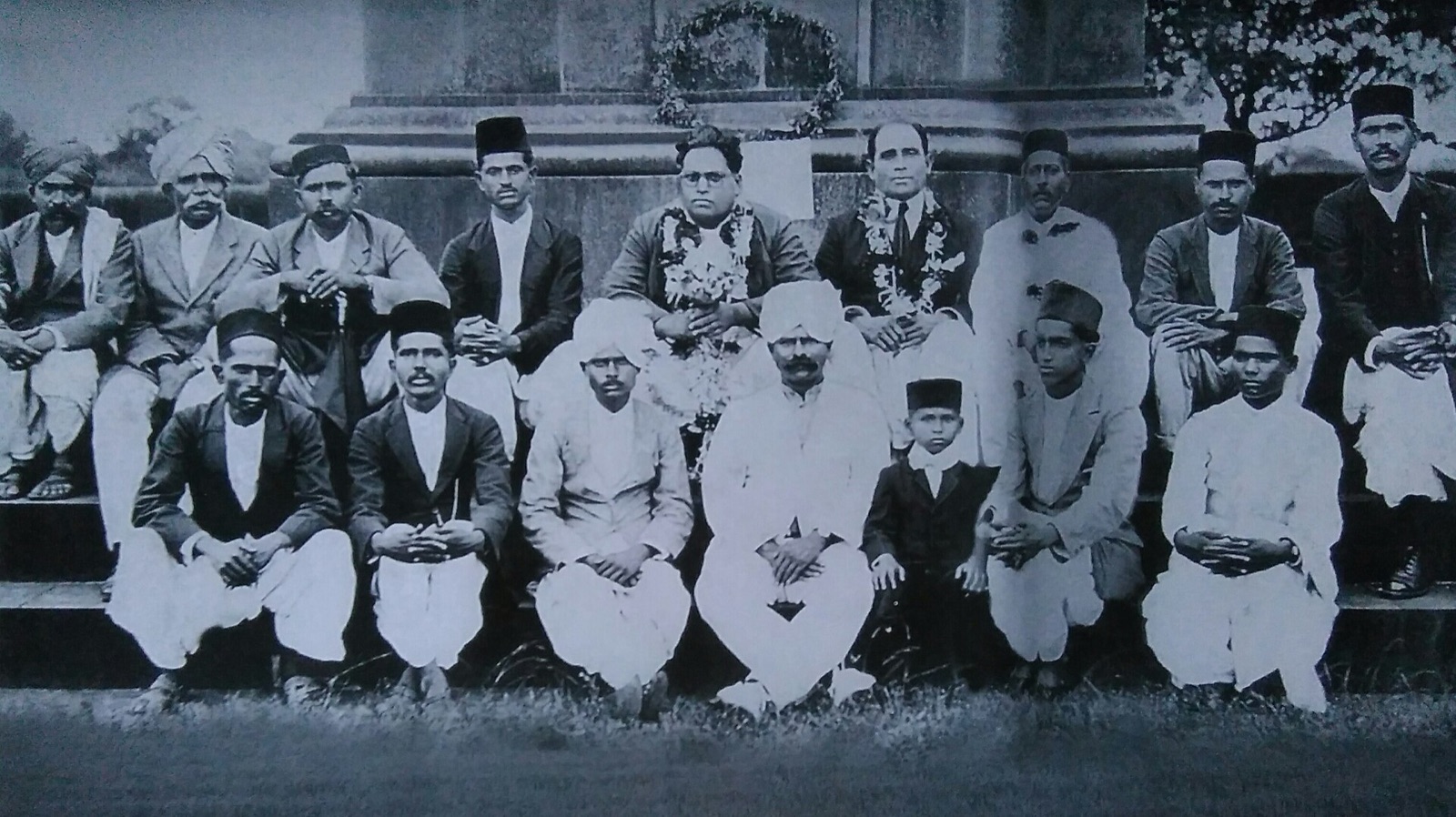 Ambedkar and his followers at the Vijaystambha (victory pillar) at Bhima Koregaon near Pune on 1 January 1927. According to the Commons description, Shivram Janba Kamble, who organised the meeting, stands to his left wearing a garland.