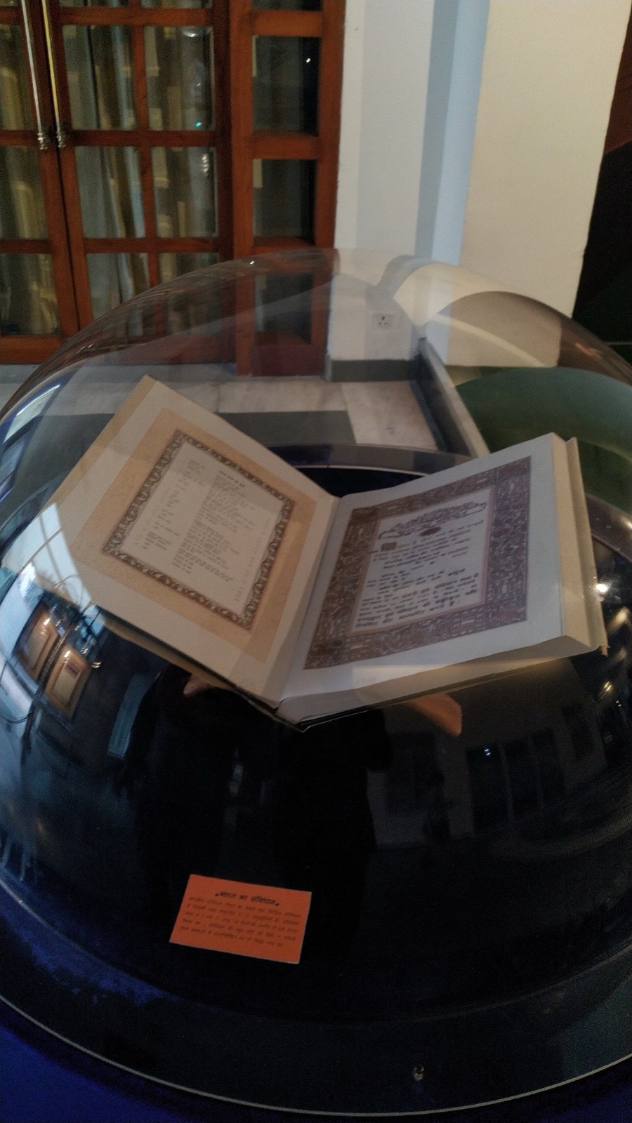 A copy of the Constitution of India kept under glass in the Rashtrapati Bhavan Museum, New Delhi. Photographed in 2024.