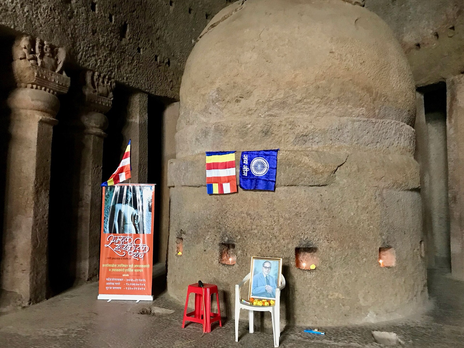 Followers of Ambedkar holding a worship session, with images of Ambedkar, at the ancient Buddhist Kanheri Caves in Mumbai. Photographed in 2018.