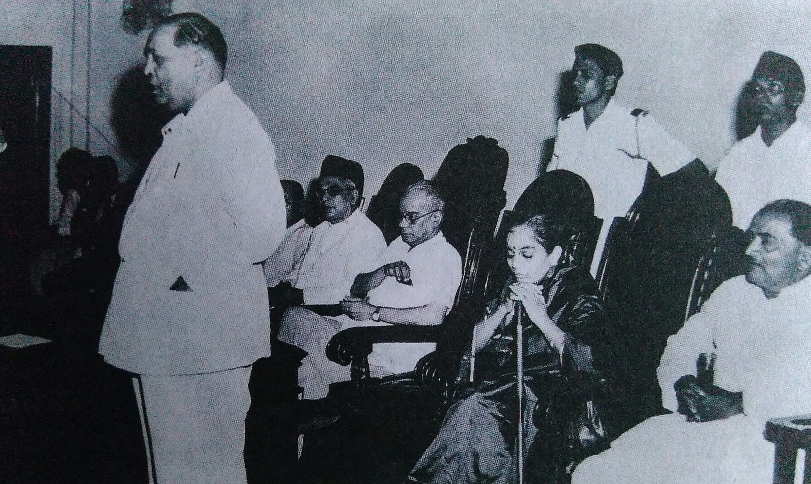 Ambedkar speaking at a meeting at Sir Cowasji Jehangir Hall, Bombay, on 19 November 1951. Seated behind are Shankarrao More, Purushottam Tricumdas, Savita Ambedkar and others; Samata Sainik Dal volunteers stand at the back.