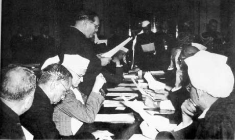 Ambedkar being sworn in as Minister of Law in August 1947, with V. N. Gadgil seated next to him and Sarvepalli Radhakrishnan on the far right, according to the Commons description.